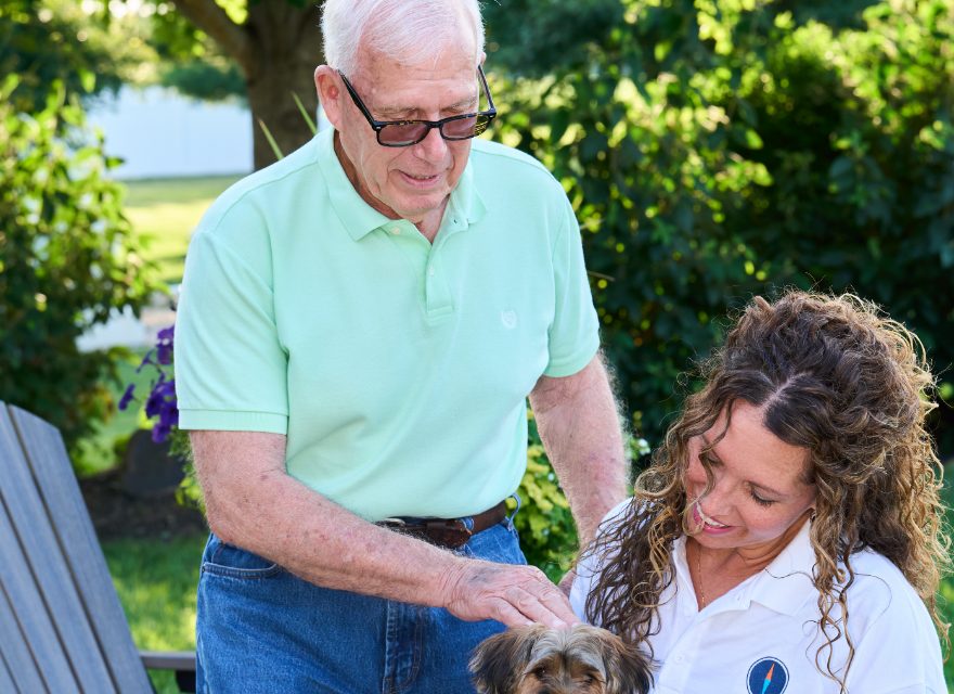 A Caregiver steadying a client in his garden