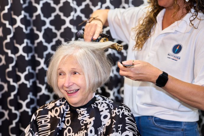 A Caregiver styling a client’s hair