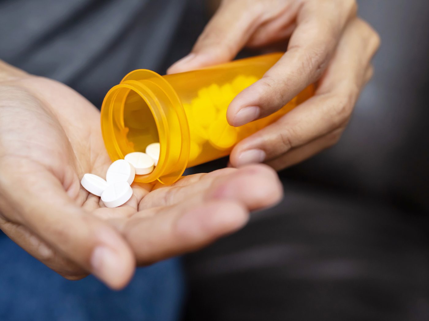 Tablets being tipped from a bottle into an open hand